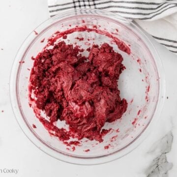 Mixed red velvet cookie dough in a mixing bowl.
