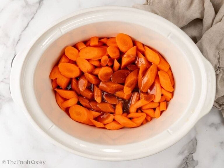 Glaze poured over the top of the carrots in the crock pot.