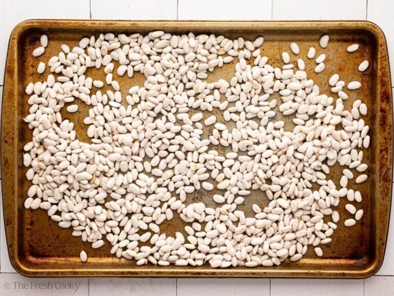 A sheet pan with dried beans on it.