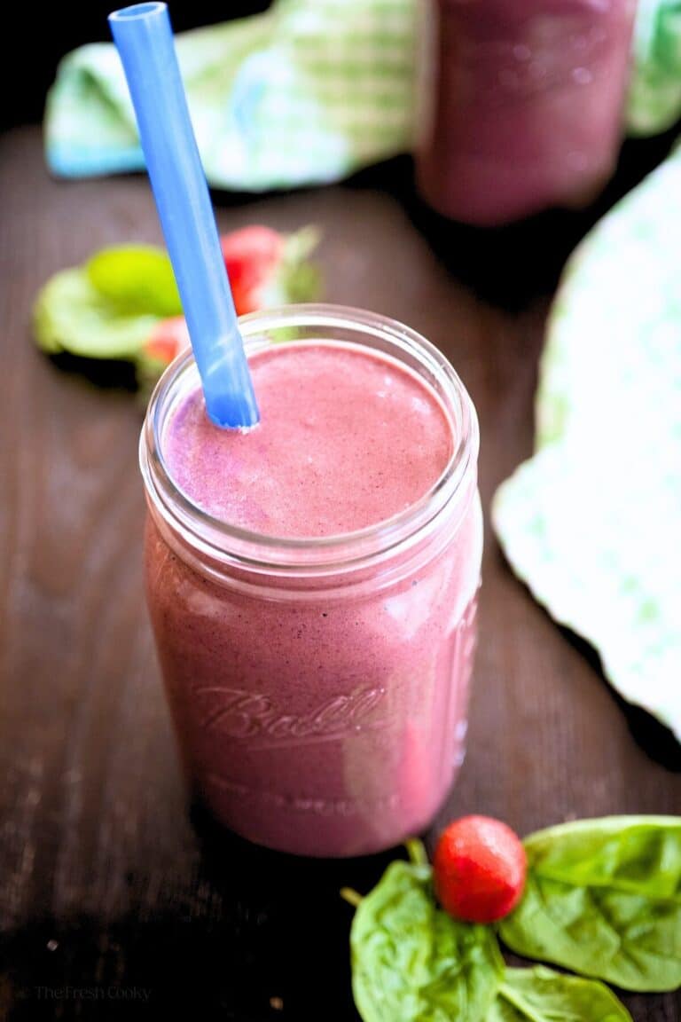 Smoothie in a tray, in a quart size mason jar with a wide mouth blue straw.