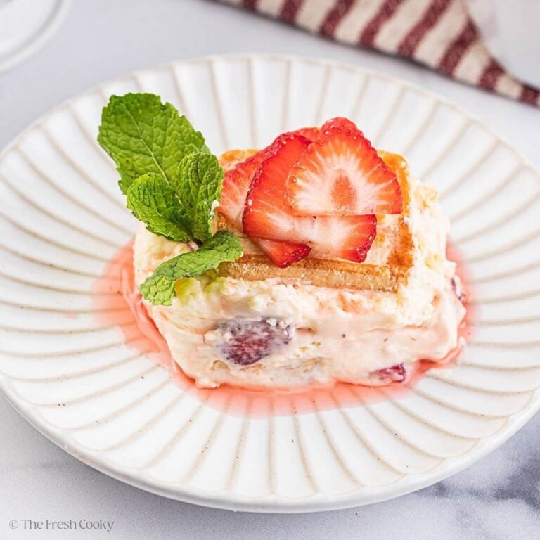 A serving of strawberry banana pudding on a white plate.
