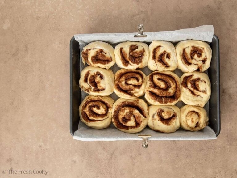 Risen cinnamon rolls in 9x13 inch pan.