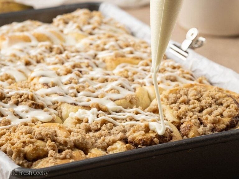 Drizzling glaze over the top of baked cinnamon rolls.