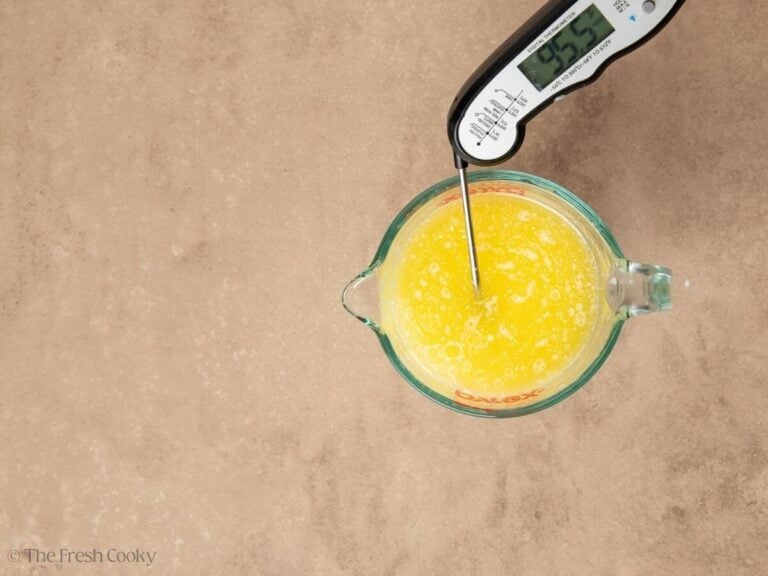 Taking the temperature of the butter and milk mixture.