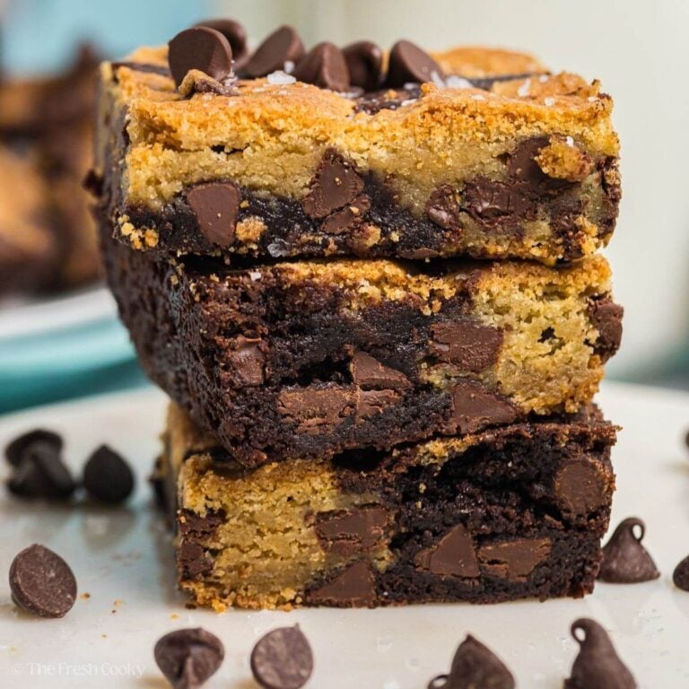 Stacked brookies (brownie + chocolate chip cookies) bars with scattered chocolate chips.