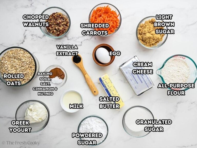 Ingredients from L-R walnuts, shredded carrots, light brown sugar, flour, granulated sugar, cream cheese, butter, egg, vanilla, baking soda, cinnamon, nutmeg, milk and rolled oats.