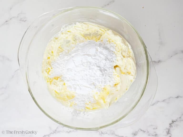 Powdered sugar on top of creamed butter and cream cheese.