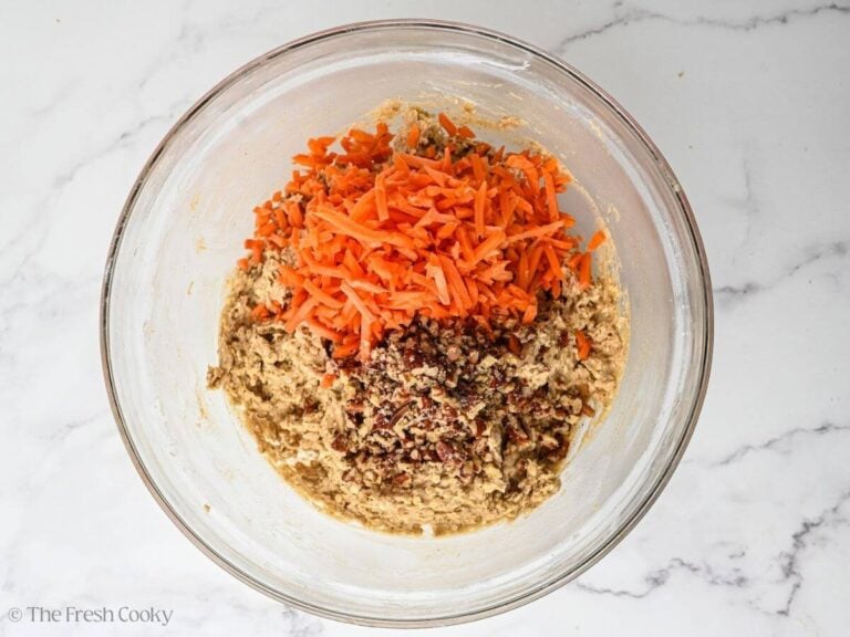 Grated carrots and chopped nuts on top of batter.