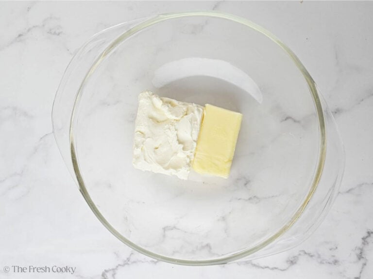 Soft butter and cream cheese in mixing bowl.