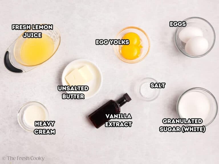 Ingredients for lemon curd: L-R: lemon juice, heavy cream, unsalted butter, egg yolks, vanilla extract, salt, eggs, and granulated sugar.