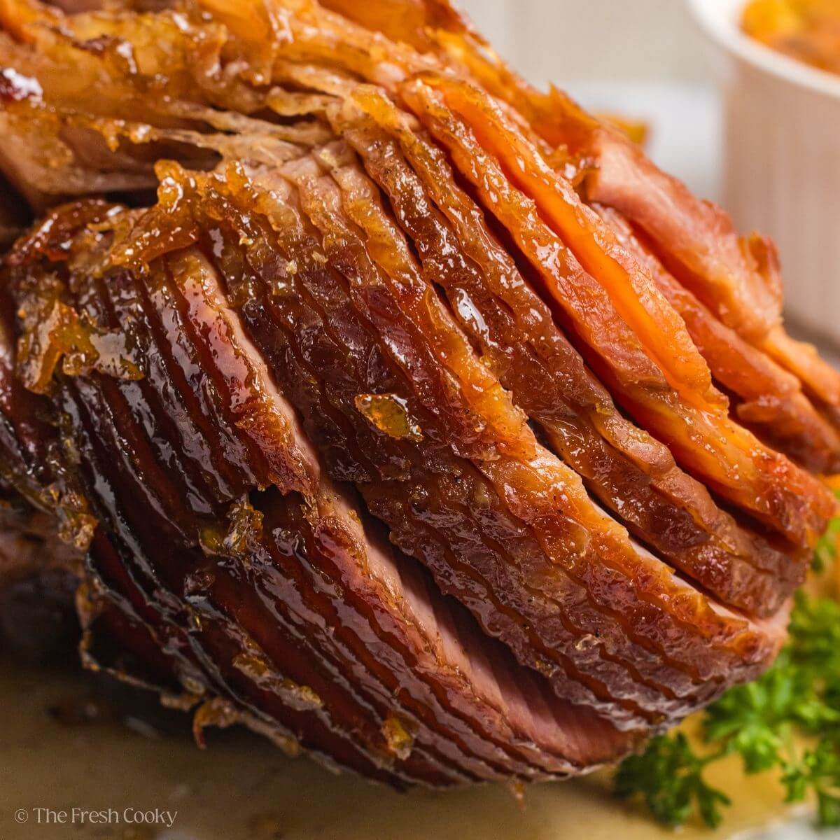 An orange glazed ham close up.