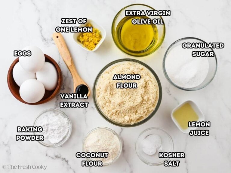 Ingredients for almond flour olive oil cake. L--R: Eggs, baking powder, zest of one lemon, vanilla extract, olive oil, almond flour, coconut flour, granulated sugar, lemon juice, and salt.