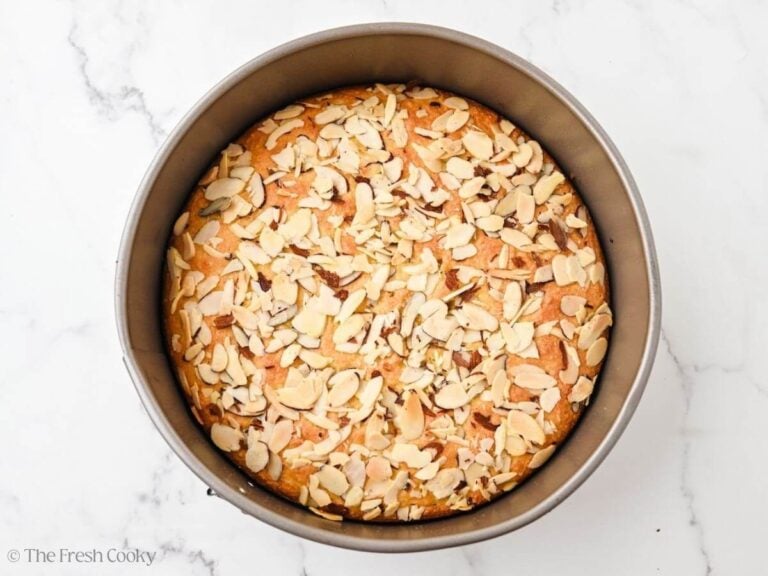 A cake pan with a baked almond flour olive oil cake.