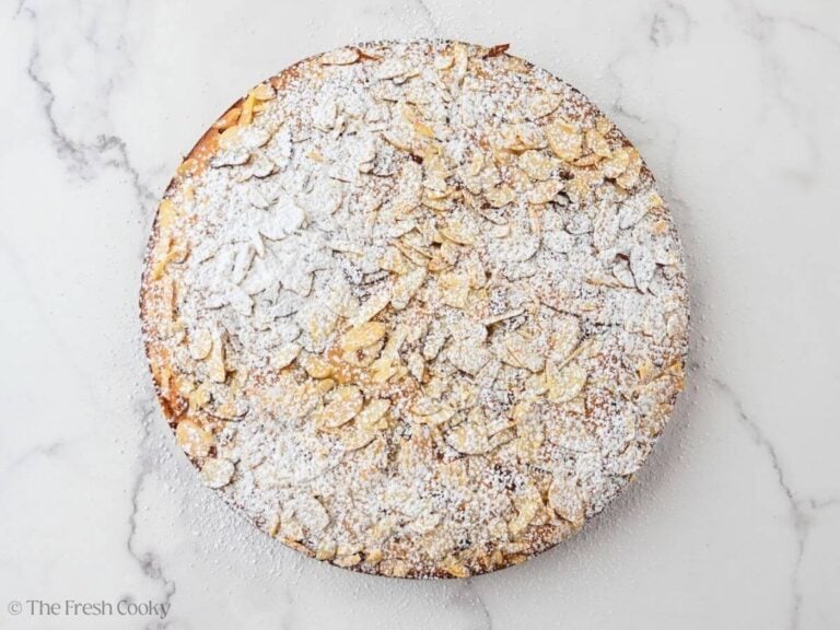 A baked almond flour olive oil cake with powdered sugar.