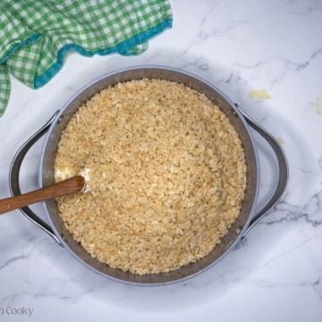 Pour in rice krispies and stir into marshmallow brown butter mixture.