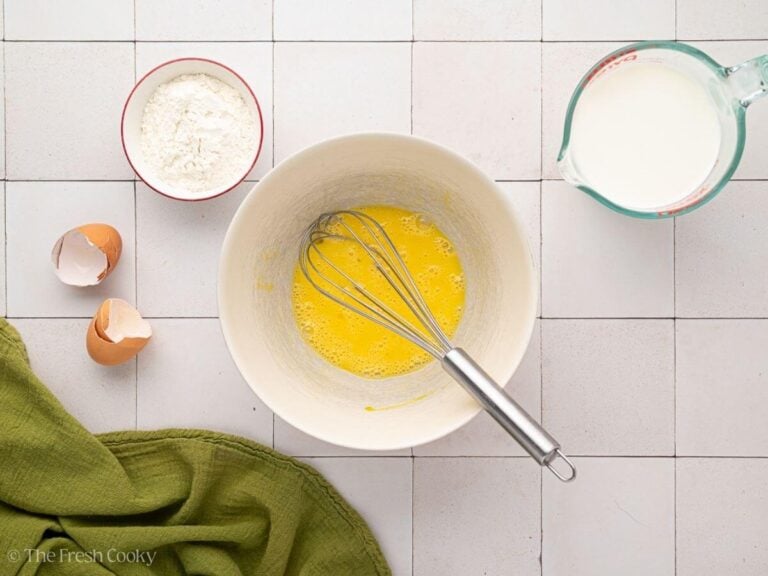 Whisking eggs in medium bowl for egg batter.