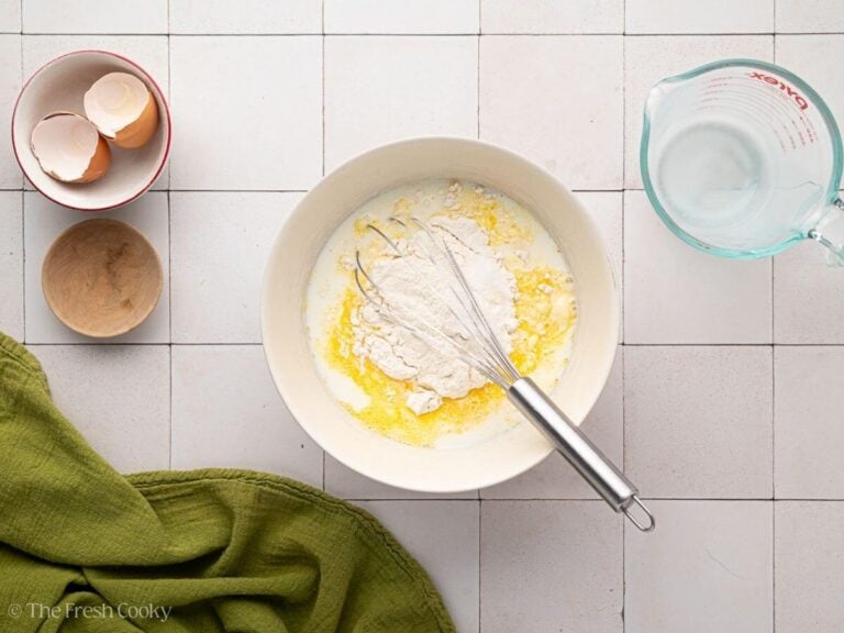 Adding flour, milk and salt to the egg mixture.