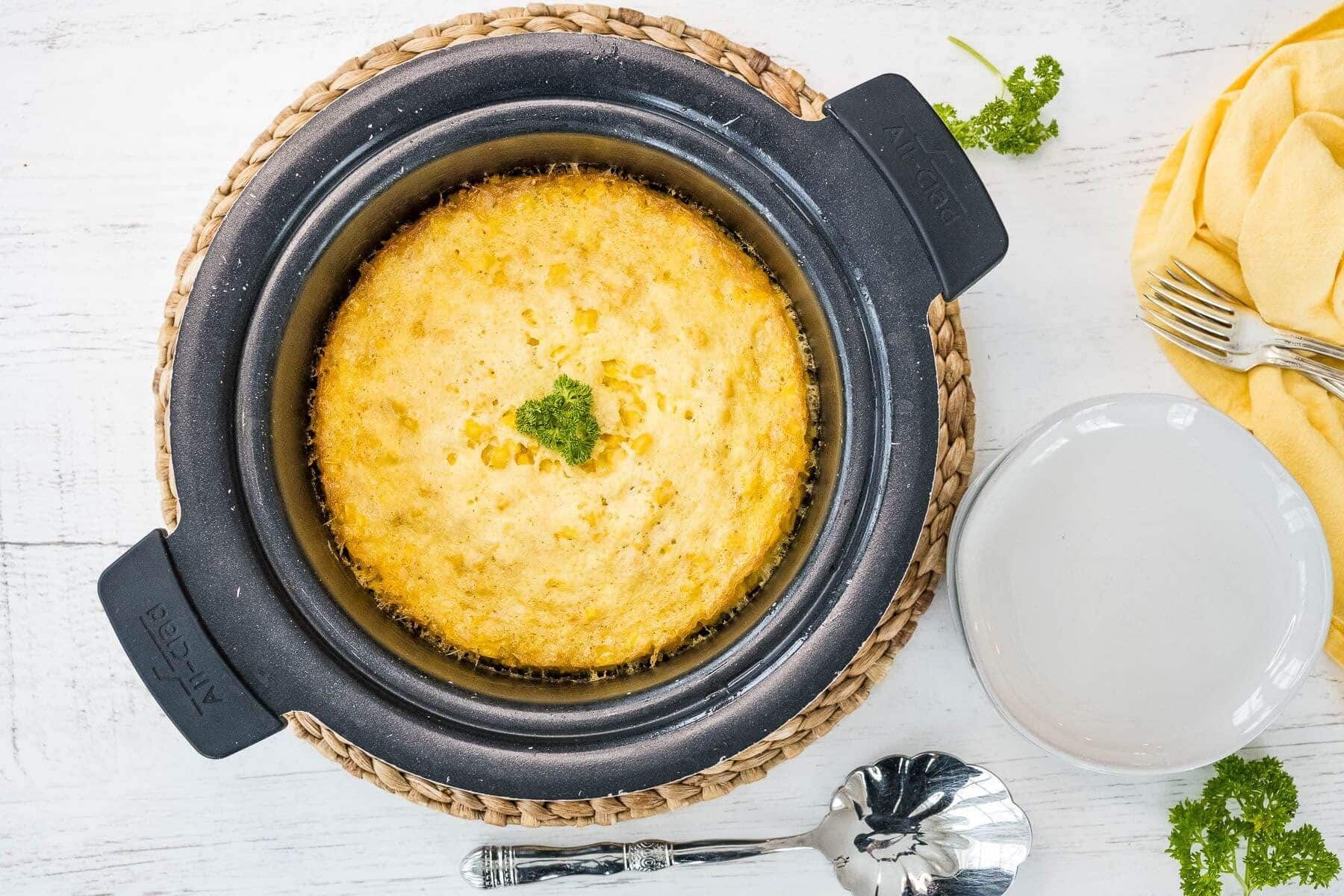 Crockpot corn casserole in round crockpot.