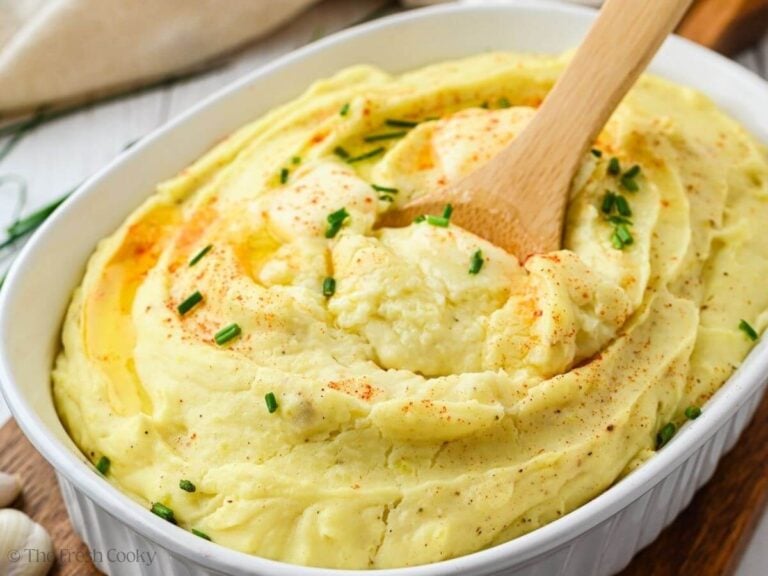 Spooning potatoes into a casserole dish.