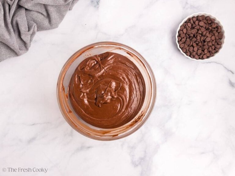 A glass bowl with chocolate cake batter.