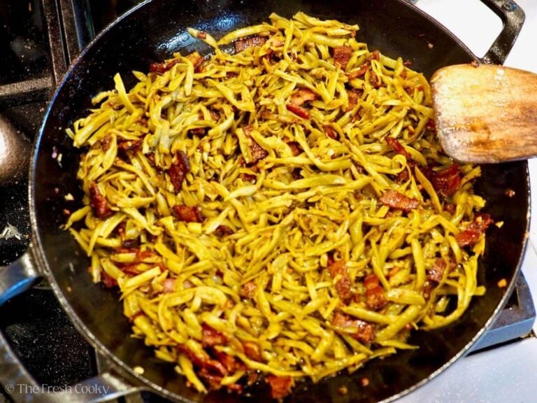 Stirring the green bean mixture to combine.