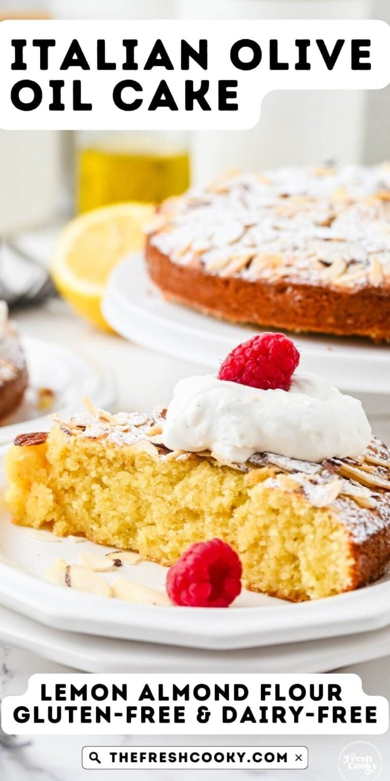 Almond flour olive oil cake slice on plate topped with whipped cream and raspberries, for pinning.