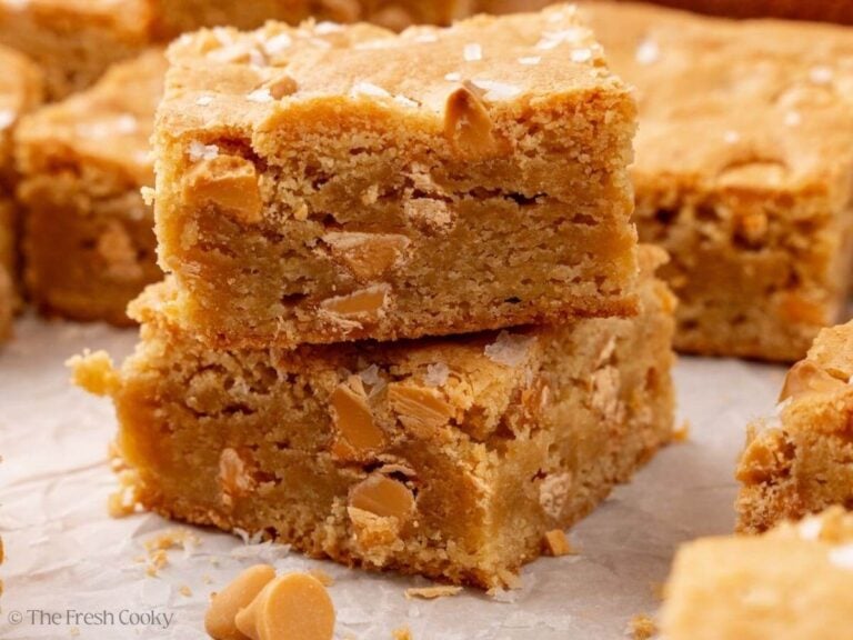 Blondies bars stacked with butterscotch chips.