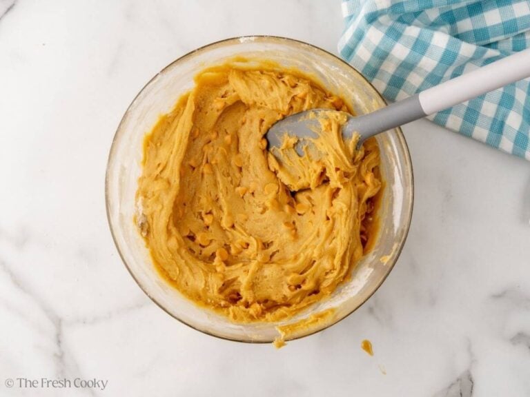 Stirring in mix-ins, butterscotch chips.