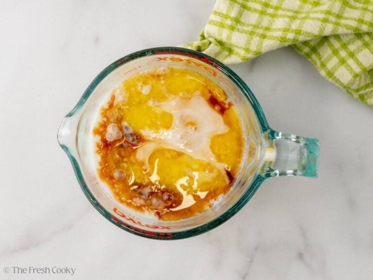 A glass measuring cup with wet ingredients for buckwheat pancakes.