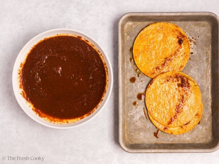 Dipping corn tortillas into the bowl of consommé.
