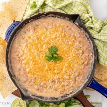 Cheese placed on top of the refried beans to serve.
