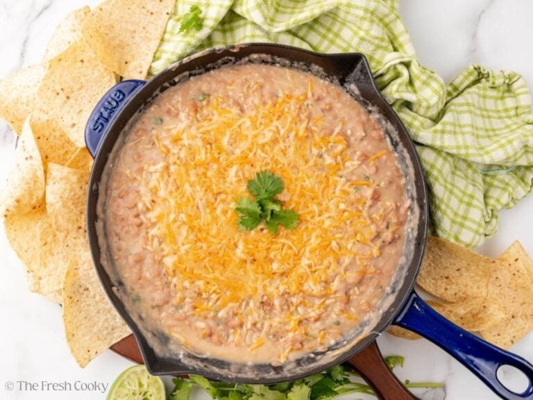 Cheese placed on top of the refried beans to serve.
