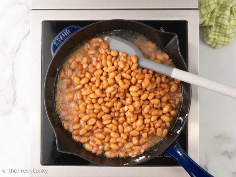 Pinto beans added to the skillet.