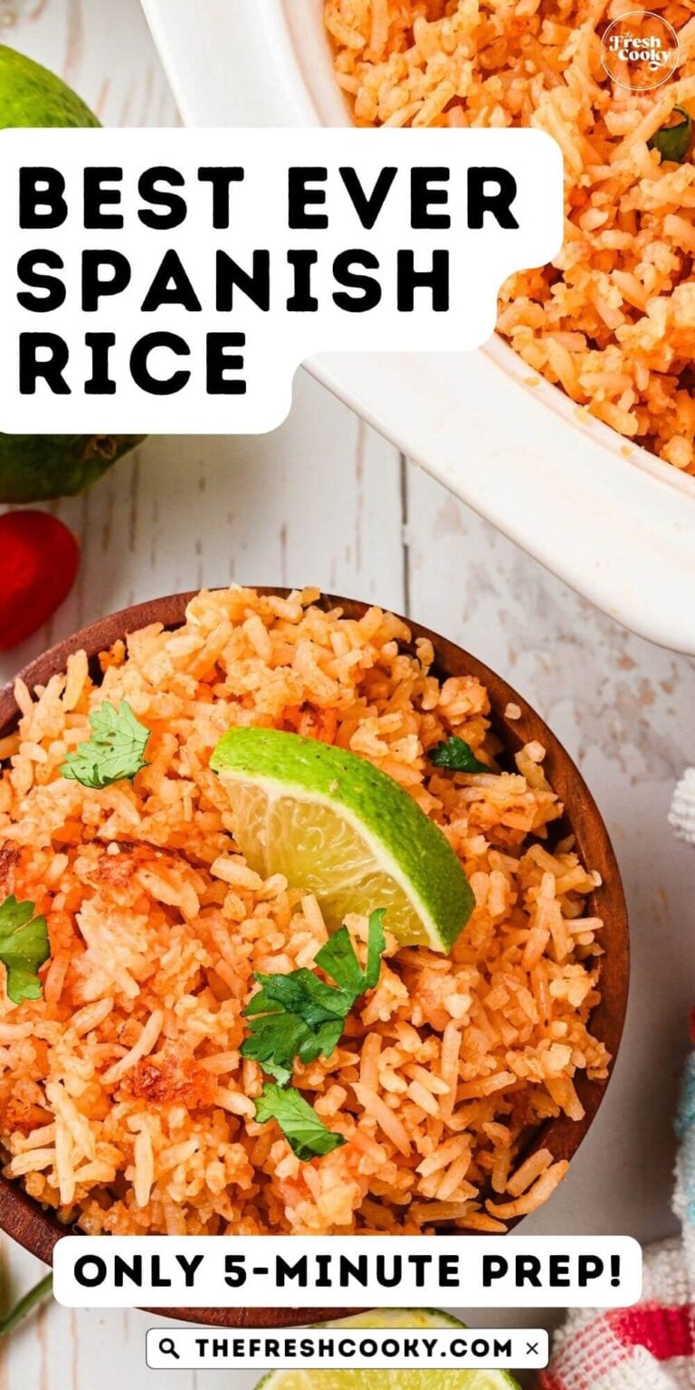 Spanish rice in wooden bowl with serving bowl nearby, for pinning.