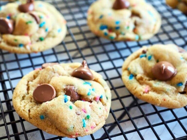 Cake batter (with sprinkles) chocolate chip cookies on a cooling rack.