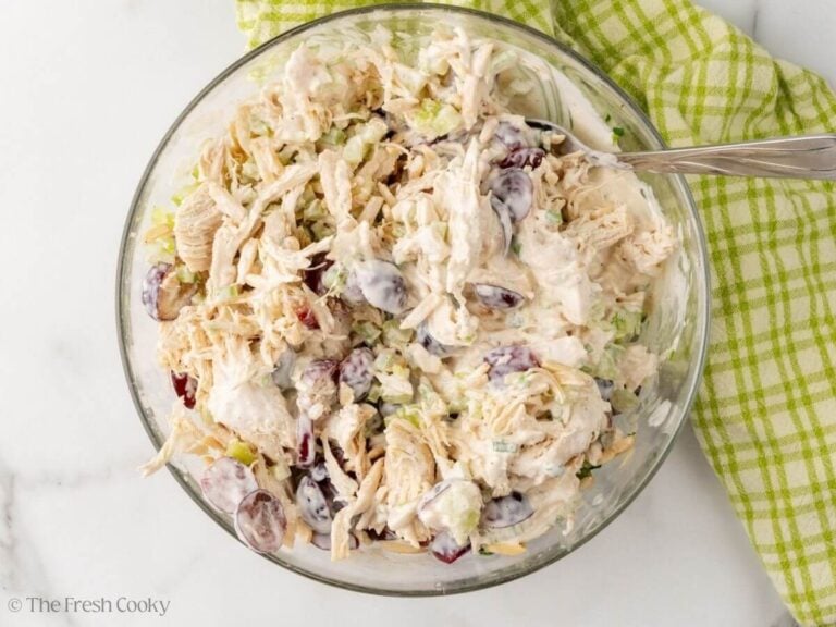 Chicken salad with grapes, tossed with dressing.