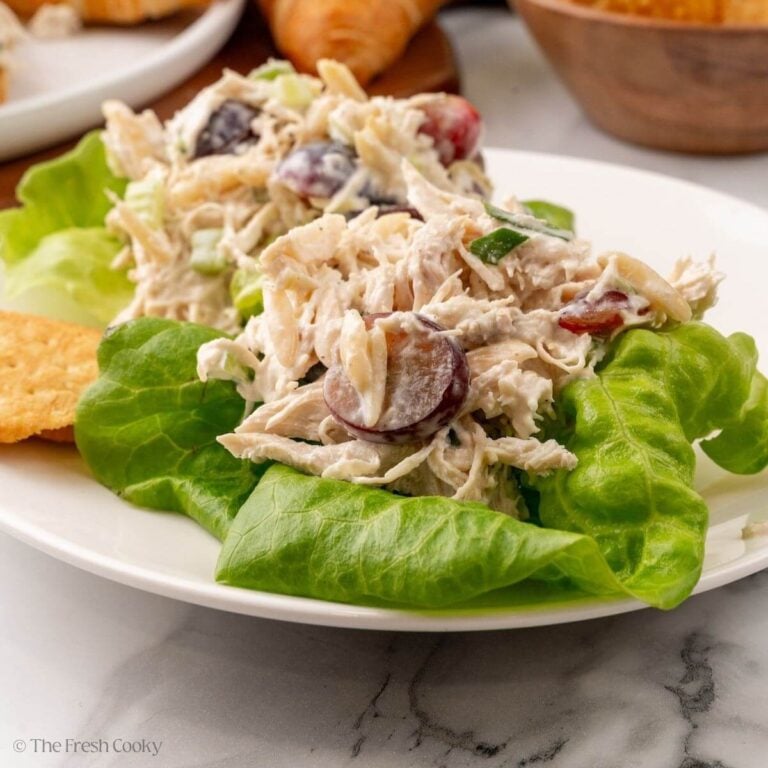 Servings of chicken salad on butter lettuce on a plate.