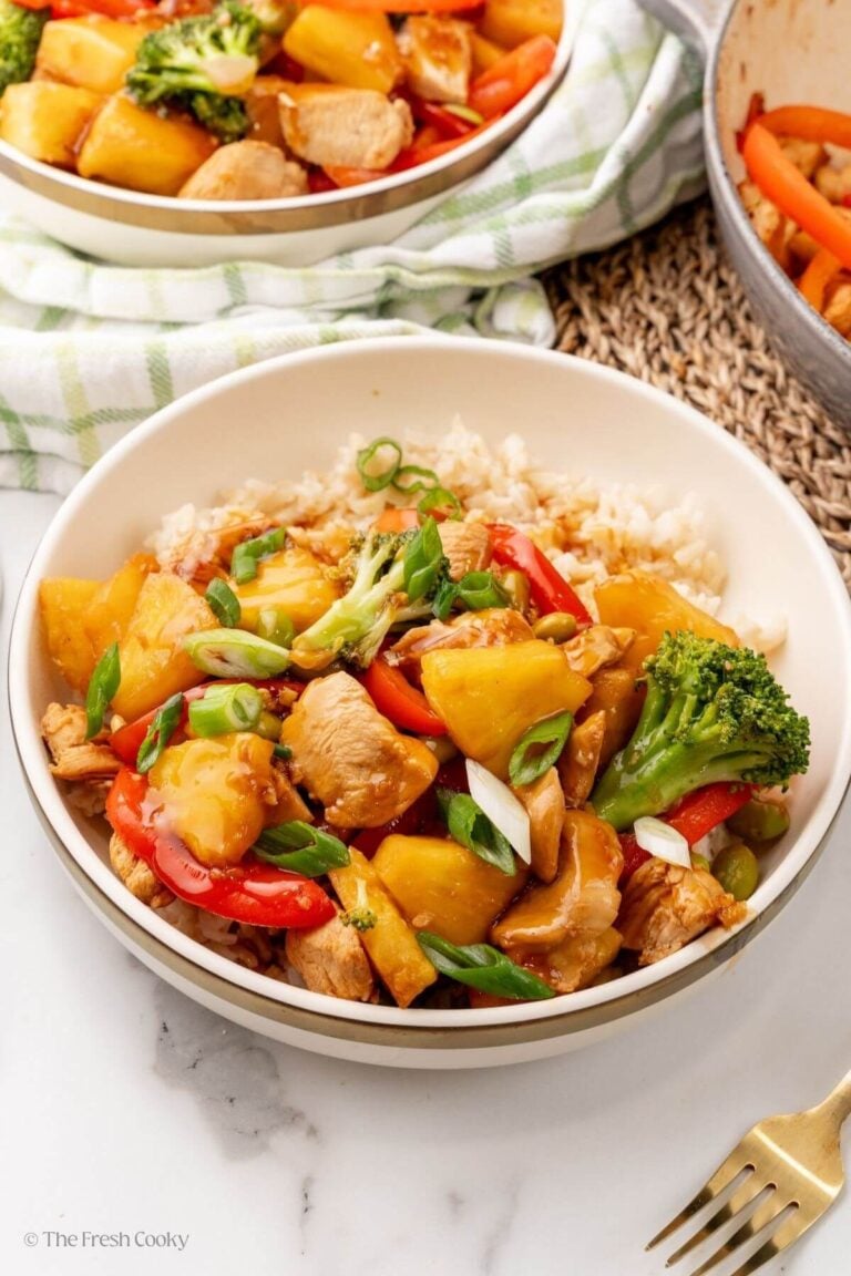 Chicken teriyaki bowl with rice, garnished with green onions on top.