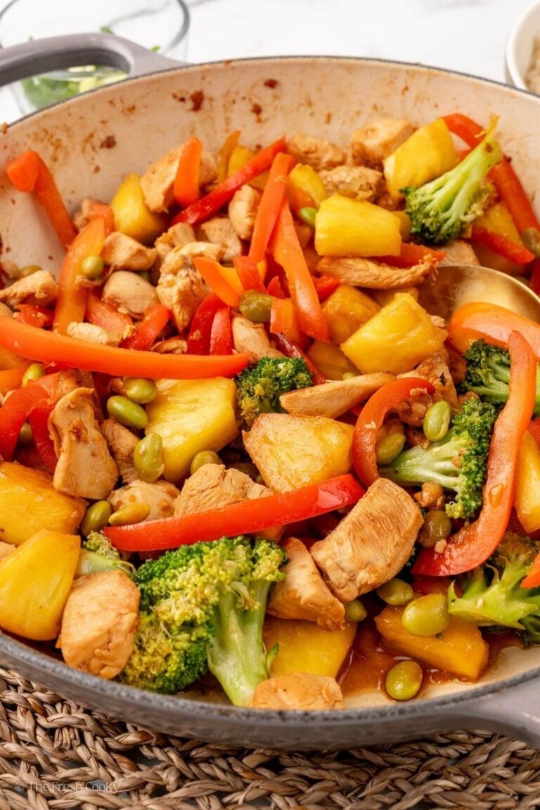 Chicken teriyaki with vegetables and pineapple in a skillet.