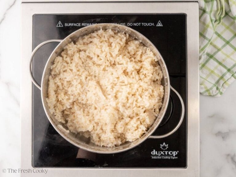 Overhead shot of rice cooking in a large pot.