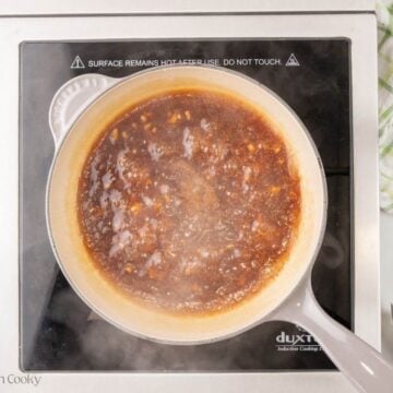 Teriyaki sauce simmering in a saucepan.