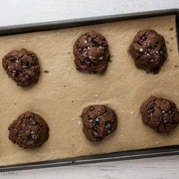 Baked banana chocolate cookies on a sheet pan.
