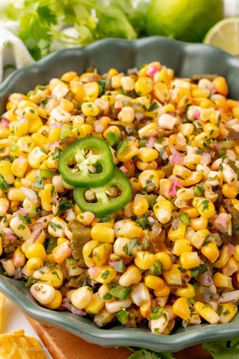 Close up of chipotle corn salsa in a bowl garnished with sliced jalapenos.
