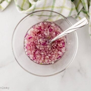 Diced red onions quick pickled in lime and lemon juice.