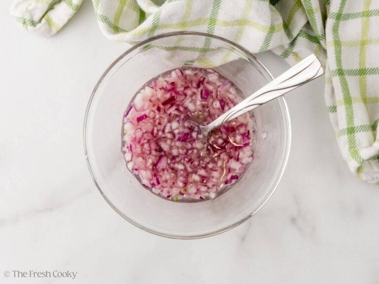 Diced red onions quick pickled in lime and lemon juice.