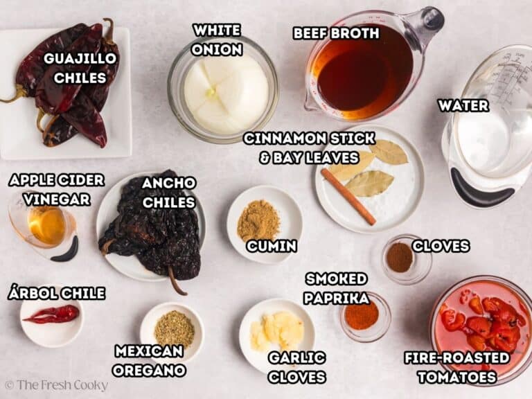 Birria sauce labeled ingredients, L-R Gaujillo chiles, white onion, beef broth, water, fire-roasted tomatoes, smoked paprika, cloves, bay leaves, cinnamon, cumin, garlic, Mexican oregano, ancho chiles, arbol chiles and apple cider vinegar.