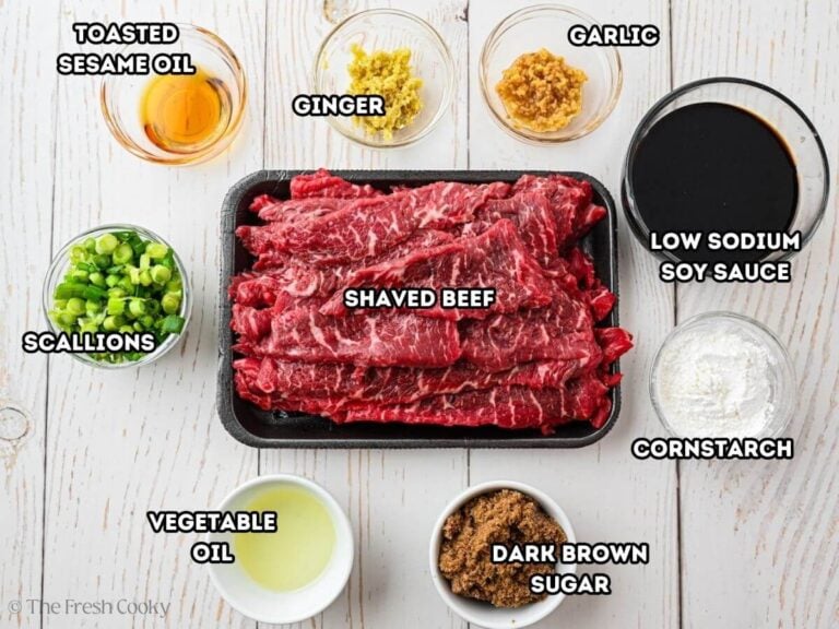 Shaved steak mongolian beef ingredients L-R toasted sesame oil, ginger, garlic, low-sodium soy sauce, cornstarch, dark brown sugar, oil, green onions, shaved steak.