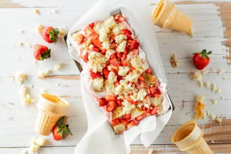Fruit and cake top layers of dessert in pan.