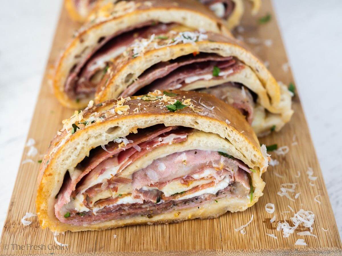 Stromboli sliced and on a cutting board.