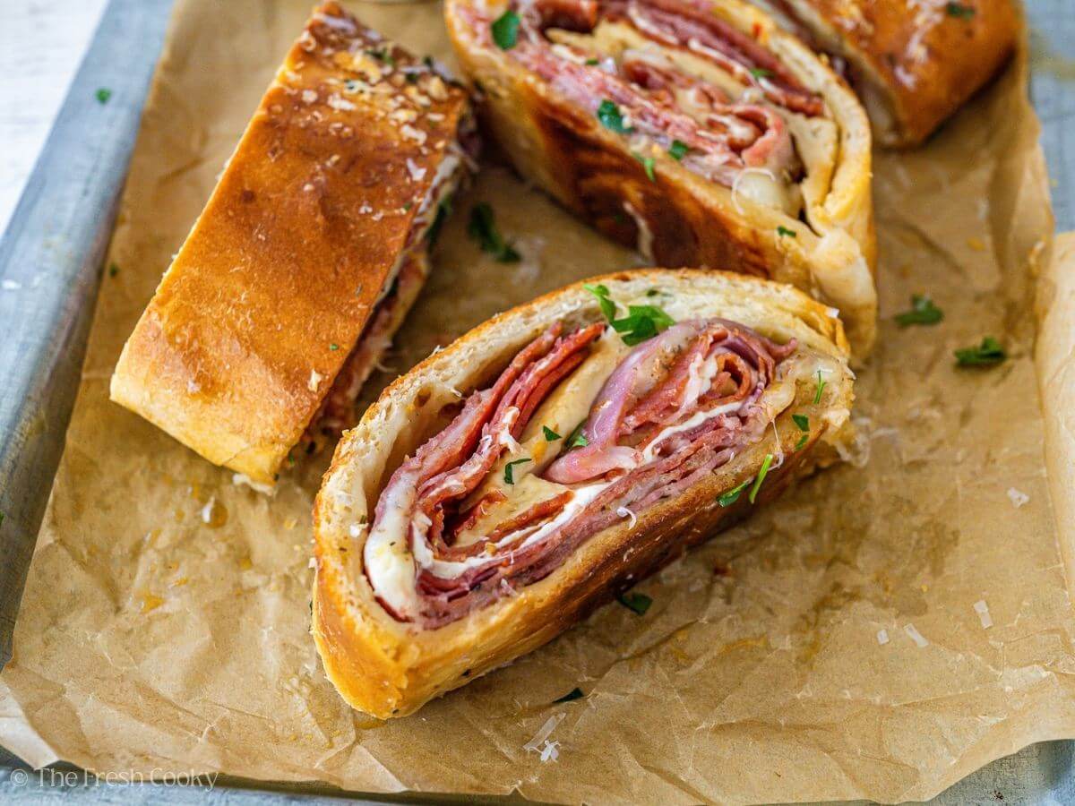 Pieces of melty cheese stromboli on a tray.